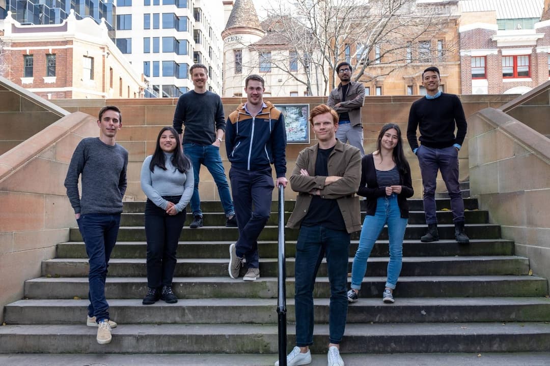 Members of the Outwrite team standing on outdoor stairs